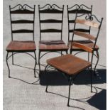 A set of four wrought iron & teak garden chairs.