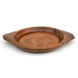 A two-handled elm dough bowl, 50cms (19.75ins) wide.