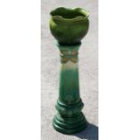 A 19th century Burmantoft green glazed jardiniere stand, 67cm (26.5ins) high, and an associated