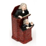 A 19th century Staffordshire figure of Rev. John Wesley preaching from the pulpit.