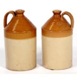 A pair of Doulton Lambeth stoneware flagons, 33cms (13ins) high.