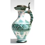 A faience pottery claret jug, 24cms (9.5ins) high.