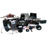 A quantity of cameras, lenses and binoculars, to include Carl Zeiss Jenoptem 8x30w binoculars; Canon