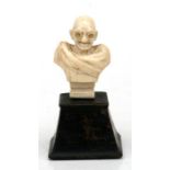 A carved ivory bust of Ghandi, 7cms (2.75ins) high.