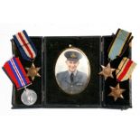 An over coloured portrait miniature of a WW2 Royal Air Force officer with gilt metal frame in a