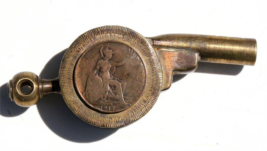 A very unusual trench art whistle in the form of a cannon with applied 1917 penny. 11cms (4.25ins)