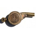A very unusual trench art whistle in the form of a cannon with applied 1917 penny. 11cms (4.25ins)