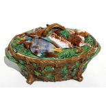 A late 19th century Minton majolica game tureen, cover and liner, the oval basket weave dish with