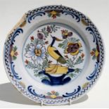 A Delft shallow bowl decorated with a bird amongst flowers, 30cms (11.75ins) diameter. Condition