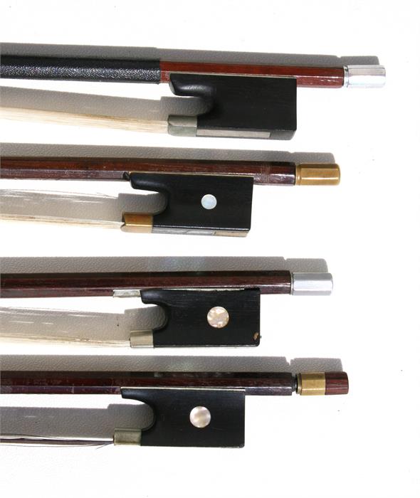 A violin bow travel case containing four violin bows.