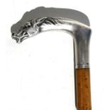 A bamboo riding crop with continental silver handle in the form of a horse's head.