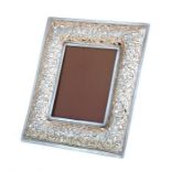 A Chinese pierced silver strut photograph frame, 16 by 19cms (6.25 by 7.5ins) overall.