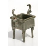 A Chinese square form censer with two scrolling handles, standing on tall legs, 13cms (5ins) high.