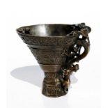 A Chinese bronze libation cup decorated with stylised dragons and multiple chilongs to handle and