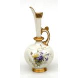 A Victorian Royal Worcester ewer painted with wild flowers and gilded decoration, with green back