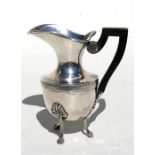 An ornate French silver cream jug with ebony handle, 12cms (4.75ins) high.
