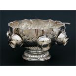 A silver plated punch bowl with cups & ladle, decorated with scrolling foliage and lion mask