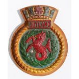 A hand painted aluminium ships crest or plaque mounted on a wooden shield to the Royal Navy Battle