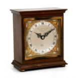 A mahogany cased mantel clock, the silvered dial with Roman numerals, signed 'Elliot, London' and