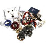 A quantity of costume jewellery to include necklaces and bracelets.