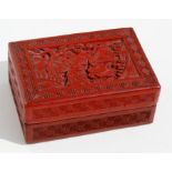 A 19th century Chinese cinnabar lacquer box decorated with seated figures in a garden, 9.7cms (3.