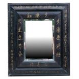 A lacquer framed wall mirror decorated with Chinese calligraphy.