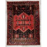 A Persian rug decorated with a geometric design, on a deep blue ground, 147 by 250cms (58 by