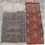 A flatweave kelim rug decorated with a geometric design, on a pale blue ground, 112 by 183cms (44 by