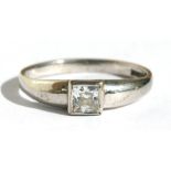 A 9ct white gold ring set with a single square cut white stone, approx UK size 'N'.