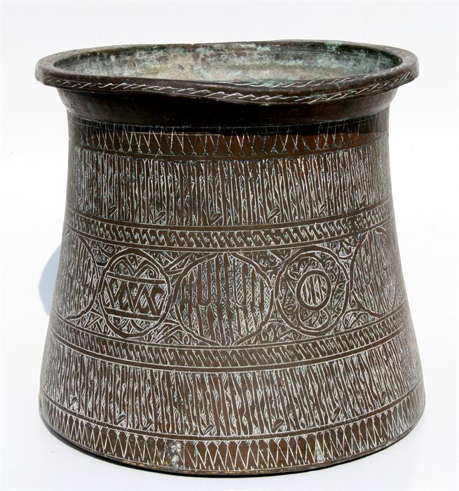 A large Eastern brass palm pot with Islamic script roundels and other engraved decoration, 31cms (