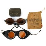 A pair of F H Hainert & Son goggles; together with another pair of goggles.