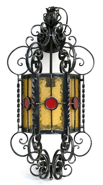 A wrought iron and coloured glass hall lantern, 65cms (25.5ins) high.