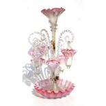 A pink vaseline glass epergne with central trumpet shaped vase, surrounded by six clear spiral twist