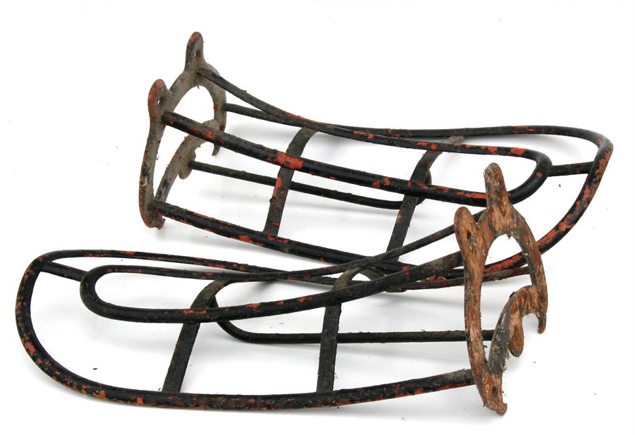 A pair of cast iron saddle racks.