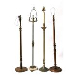 Two brass standard lamps and two wooden standard lamps (4).