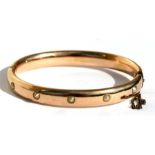 A Victorian unmarked rose gold bangle set with five half pearls. Condition Report There are some