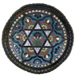 A Syrian enamelled copper tray decorated with a central flower within a star and calligraphy. 31cm