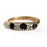 A 9ct gold ring set with three sapphires and two diamonds, approx UK size 'K'.