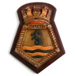 A hand painted aluminium ships crest or plaque mounted on a wooden shield to the WW2 Royal Navy