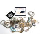 A quantity of costume jewellery to include necklaces and bangles.