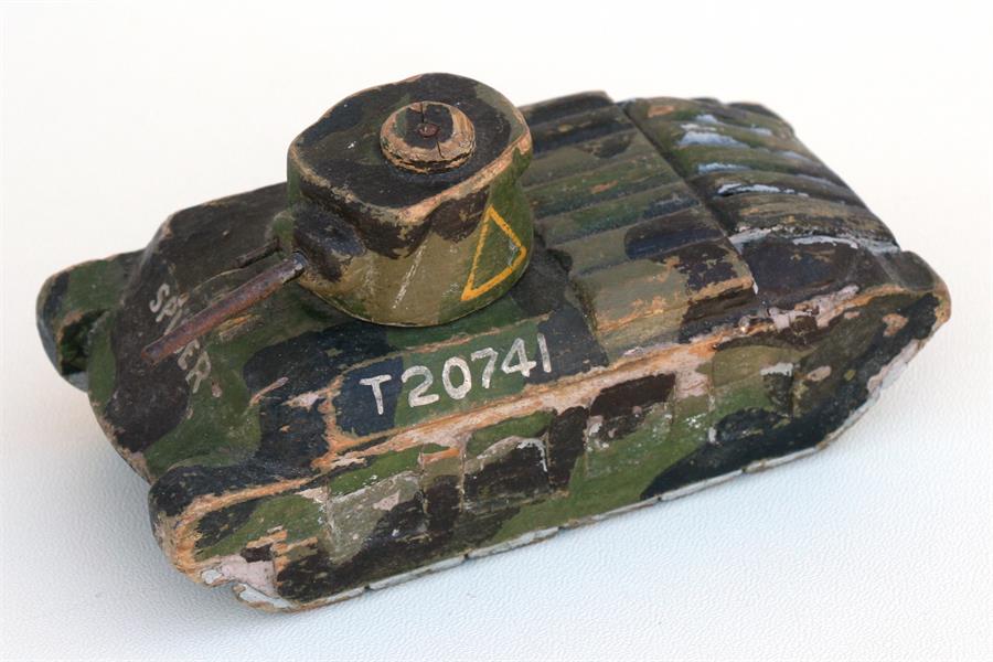 A hand carved and painted model of a WW2 Matilda tank. Having a revolving turret. Length 15cms (
