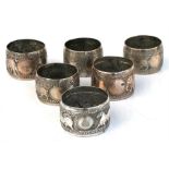A set of six Indian silver plated napkin rings decorated with animals.