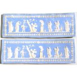 A pair of Wedgwood Jasperware style panels decorated with classical scenes, 46cms (18ins) wide.
