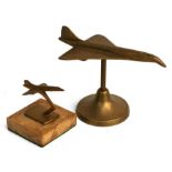 Two brass models of Concorde on stands. 19cms (7.5ins) and 8cms (3.125in) long respectively