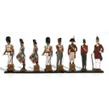 A group of hand painted wooden soldiers in dress uniform, some mounted with calendars dating from