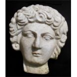A white marble carving in the form of a Greco-Roman face with wavy hair. 46cm (18ins) high