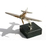 A chrome plated and brass model of a WW2 Spitfire standing on a marble base. Wingspan 17cms (6.