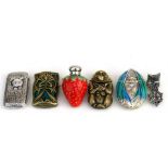 A sterling silver vesta case; three other vesta cases and a strawberry form scent bottle on stand (