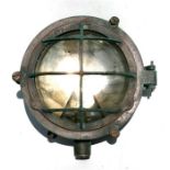 A bronze bulkhead lamp with the remains of a Military arrow mark, 25.5cms (9.75ins) diameter.