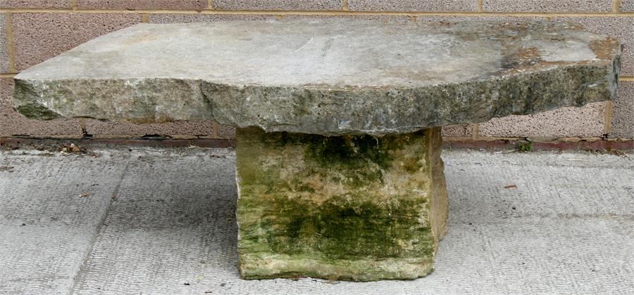 A well weather Purbeck stone garden table. 156cm (61.5 ins) wide